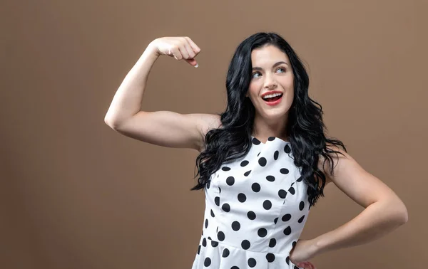 Powerful young woman in success pose