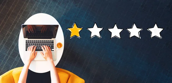 One Star Rating with person using a laptop — Stock Photo, Image