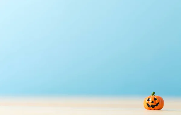 Tiny Halloween pumpkin on a table — Stock Photo, Image