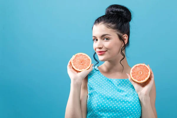 Счастливая молодая женщина с апельсинами — стоковое фото