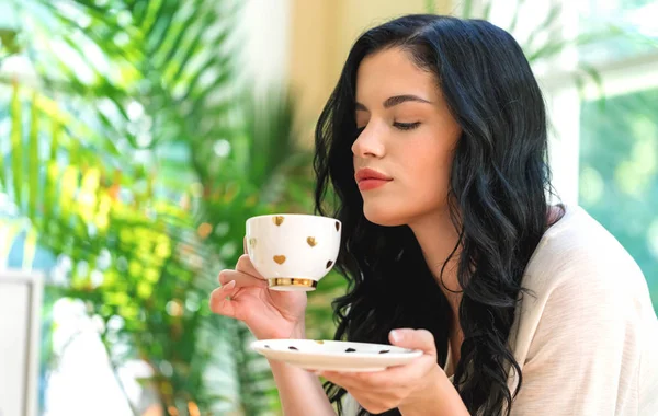 Egy fiatal nő kávét iszik. — Stock Fotó