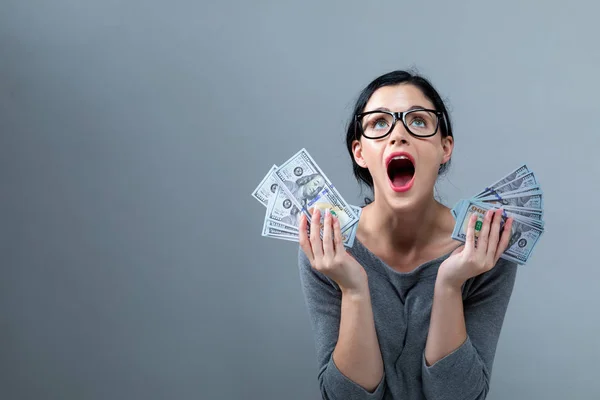 Young woman with a stack of cash USD — Stock Photo, Image