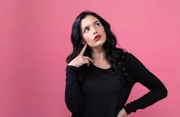 Young woman in a thoughtful pose