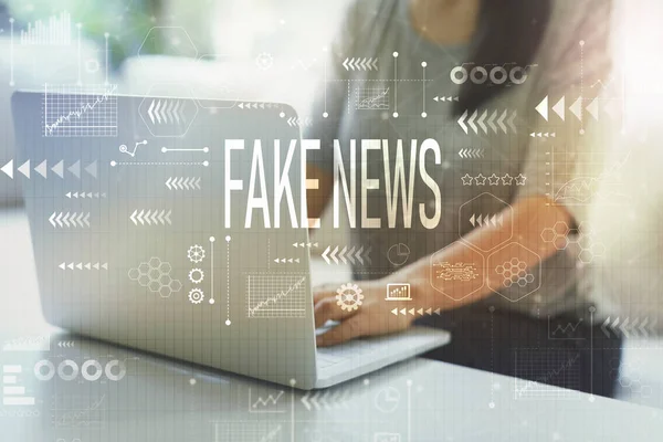 Fake news with woman using laptop — Stock Photo, Image