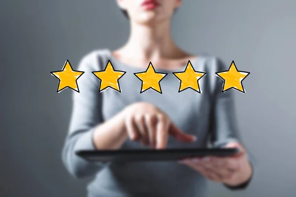 Five star rating with woman using a tablet — Stock Photo, Image