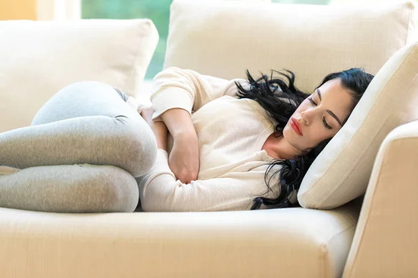 Young woman suffering from stomach pain — Stock Photo, Image