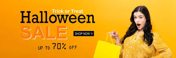 Halloween sale with woman holding shopping bag — Stock Photo, Image