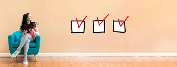 Checklist with woman using a tablet — Stock Photo, Image