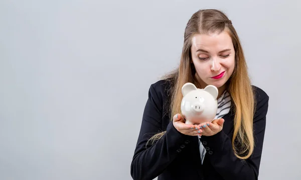 Young woman with a piggy bank — Stock Photo, Image