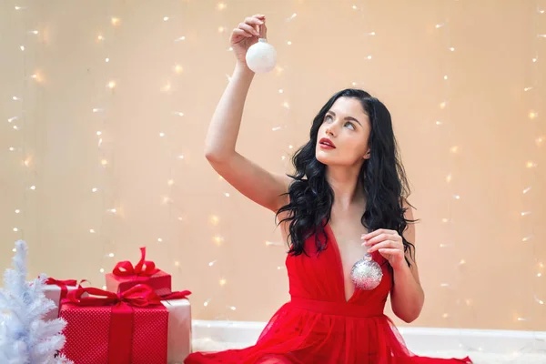 Happy young woman holding Christmas baubles — Stock Photo, Image