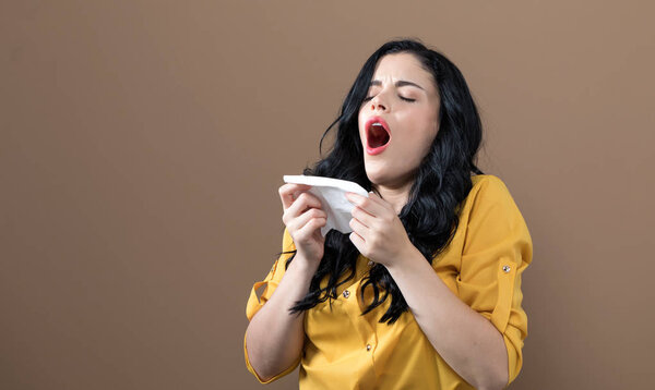 Sick young woman with tissues