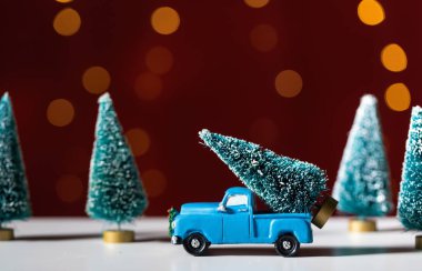 Bir Noel ağacı taşıyan oyuncak kamyon