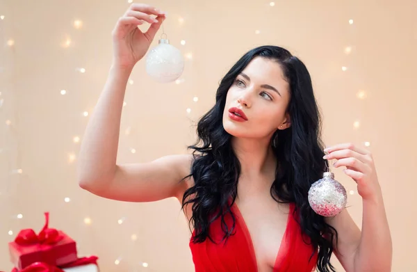 Happy young woman holding Christmas baubles — Stock Photo, Image