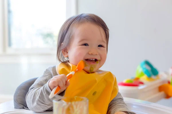 Happy toddler boy eating a meal — Stock Photo, Image