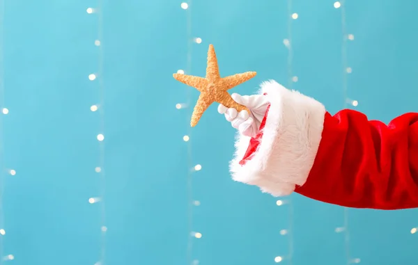 圣诞老人拿着一只海星 — 图库照片