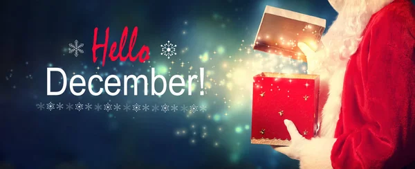 Aralık mesajı bir hediye kutusu açma Santa ile Merhaba — Stok fotoğraf