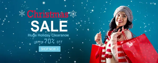 Christmas sale message with woman holding shopping bags — Stock Photo, Image