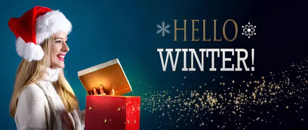 Hello winter message with woman opening a gift box — Stock Photo, Image