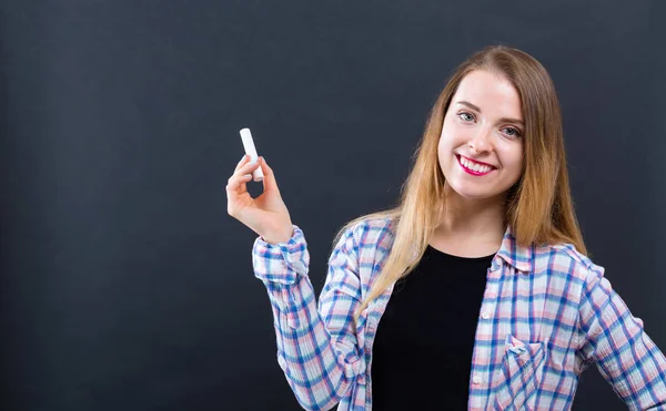 Mujer sosteniendo una tiza — Foto de Stock