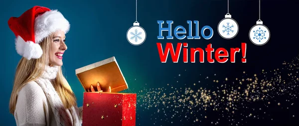 Hello winter message with woman opening a gift box — Stock Photo, Image