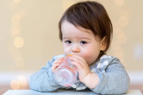 Toddler boy drinking juice — Stock Photo, Image