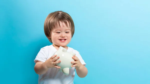 Toddler boy with a piggy bank — Stock Photo, Image