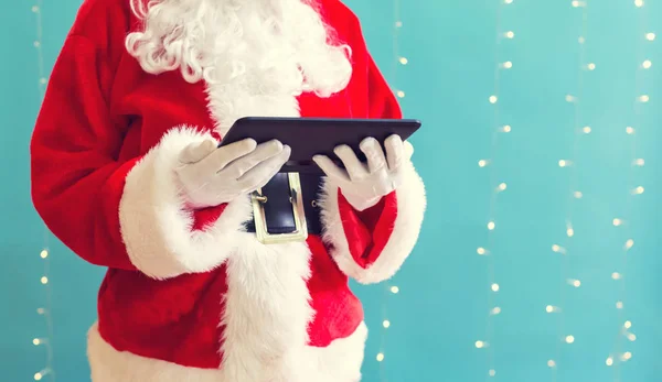 Santa držet tabletový počítač — Stock fotografie