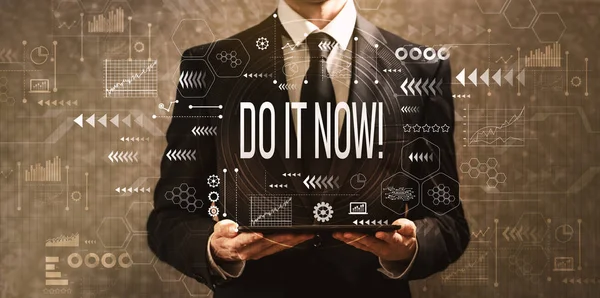Do it now with businessman holding a tablet computer