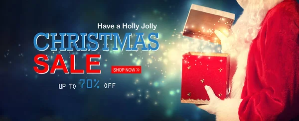 Christmas sale message with Santa opening a gift box — Stock Photo, Image