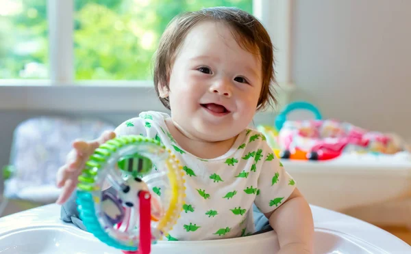 Happy boy playing with his toys — Stock Photo, Image