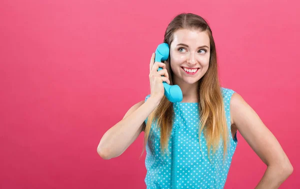 Jonge vrouw praten over oude ouderwetse telefoon — Stockfoto