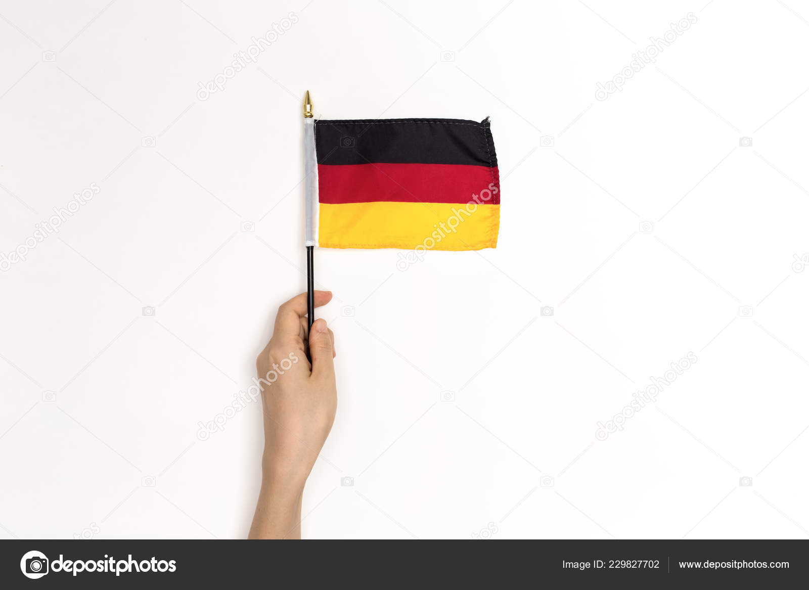 Person Holding A German Flag Stock Photo By ©melpomene 229827702
