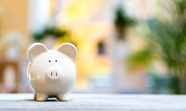 Piggy bank in a bright room — Stock Photo, Image