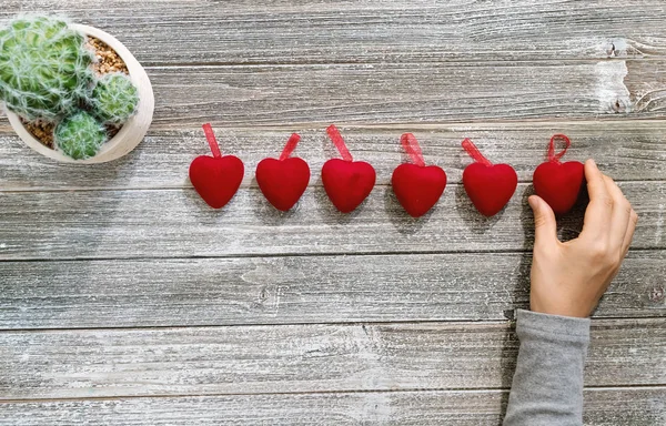 Persona che tiene ornamenti a forma di cuore — Foto Stock