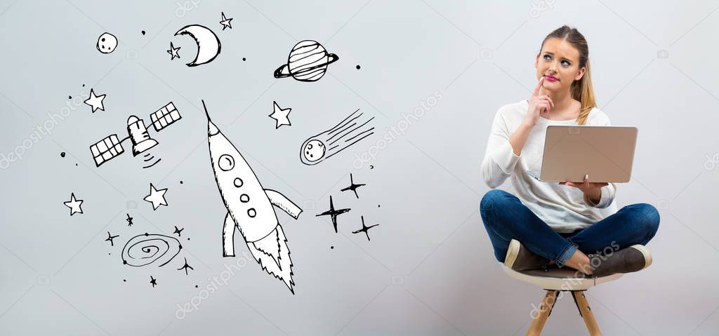 Dream of space and rocket with young woman using her laptop 