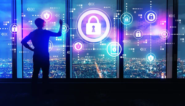 Cyber security with man by large windows at night — Stock Photo, Image