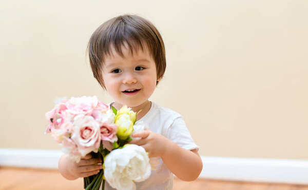 Toddler boy with flowers