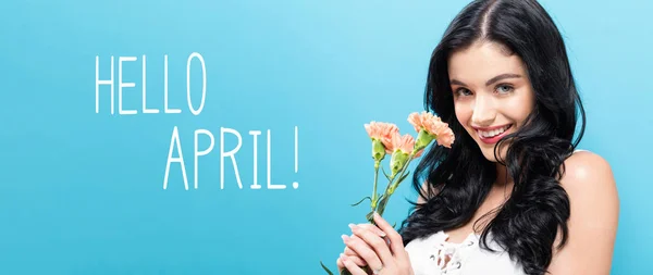 Hello April message with young woman holding carnations — Stock Photo, Image