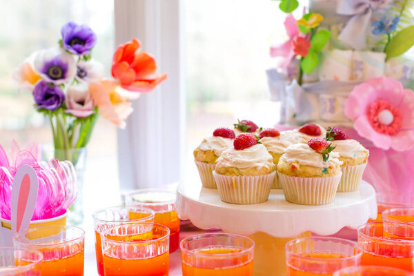 Dessert table with cupcakes and flowers