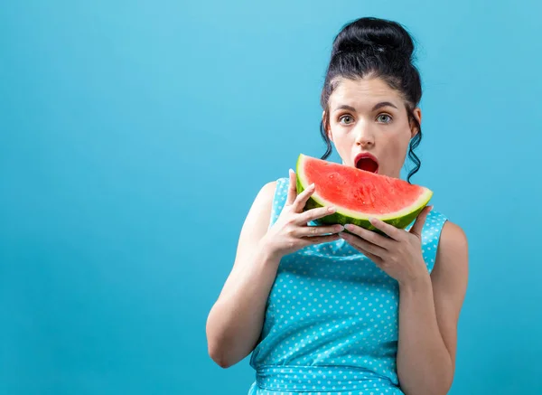 Young woman holding watermelon