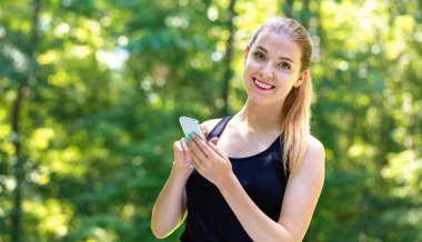 Genç bayan telefonunu kullanıyor.