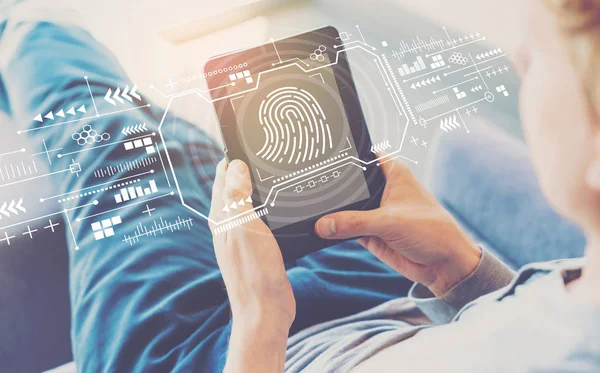Fingerprint scanning theme with man using a tablet — Stock Photo, Image