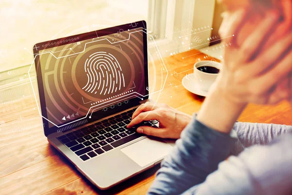 Fingerprint scanning theme with man using a laptop — Stock Photo, Image