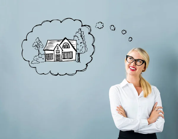 Dreaming of new home with young woman — Stock Photo, Image