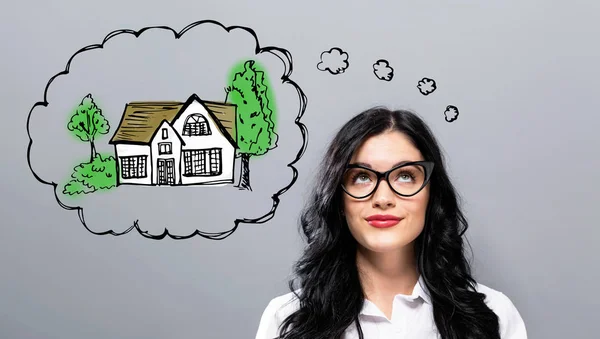 Dreaming of new home with young businesswoman — Stock Photo, Image