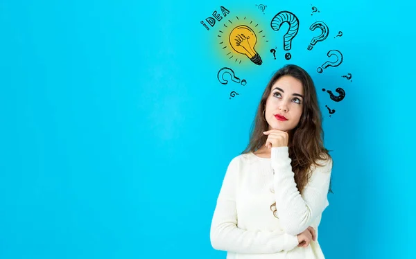 Idea light bulbs with question marks with young woman — Stock Photo, Image