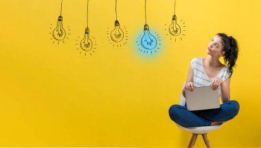 Bir dizüstü bilgisayar kullanarak kadın ile Fikir ampuller