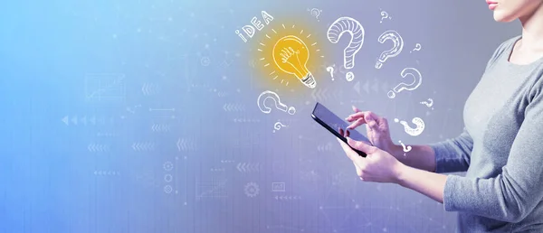 Idea light bulbs with question marks with woman using a tablet — Stock Photo, Image