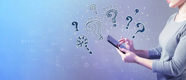 Question marks with woman using a tablet — Stock Photo, Image