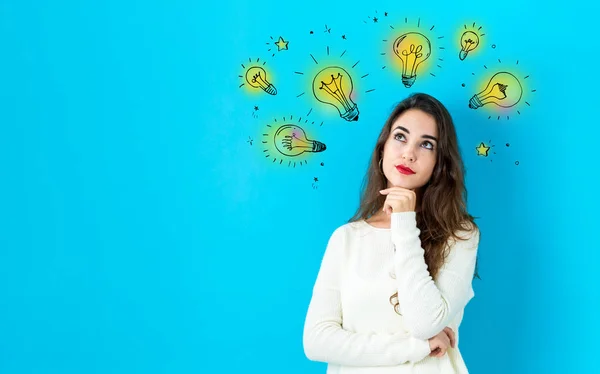 Idea light bulbs with young woman — Stock Photo, Image